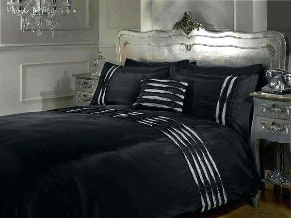 black white and silver bedding set in bedroom interior