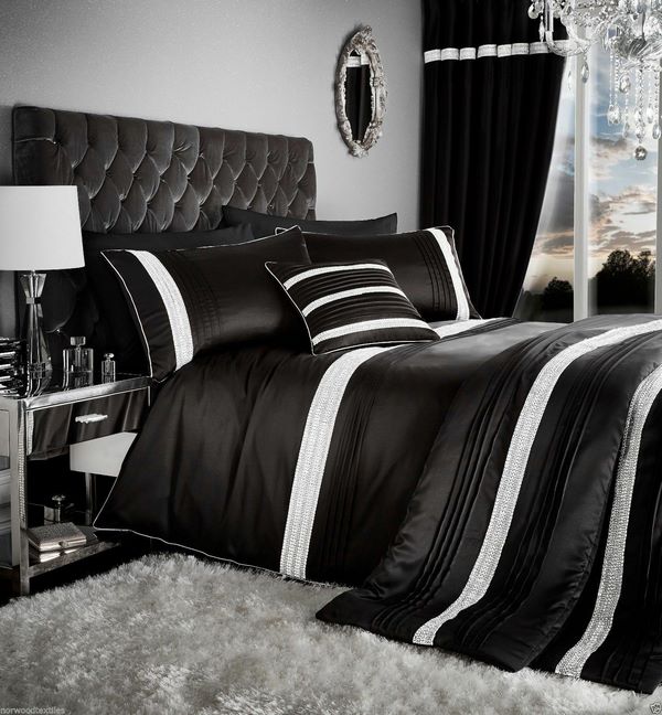 black bed sheets tufted headboard and shaggy rug