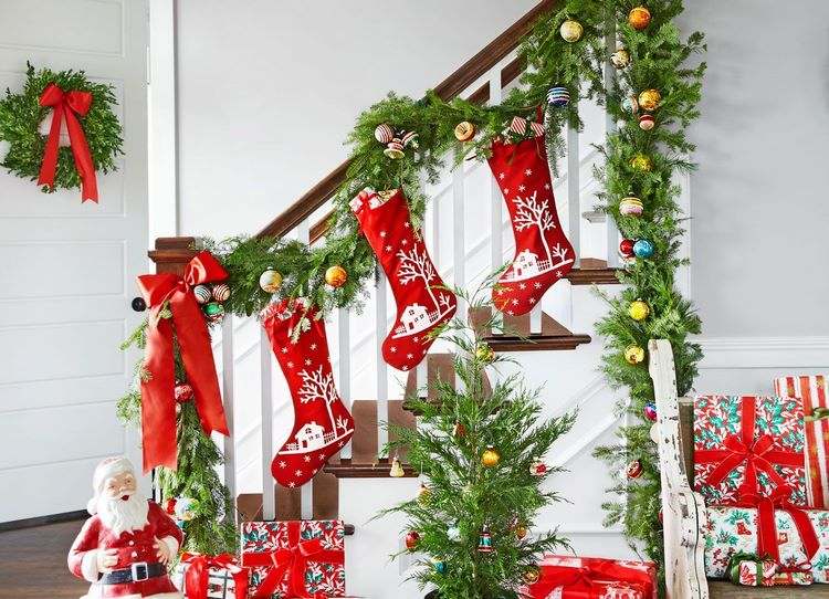 Christmas themed textile stockings and decorative pillows green garlands