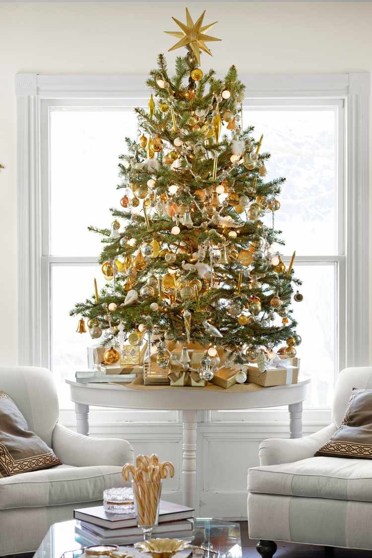 Christmas tree decorated in white and gold with star topper