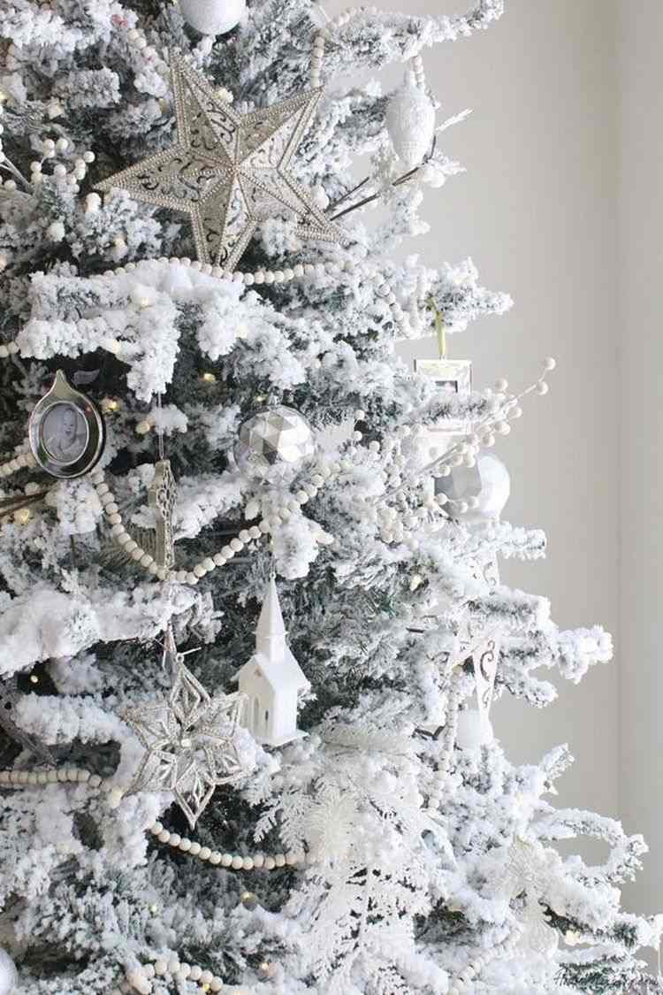 flocked Christmas tree decoration with white and silver ornaments