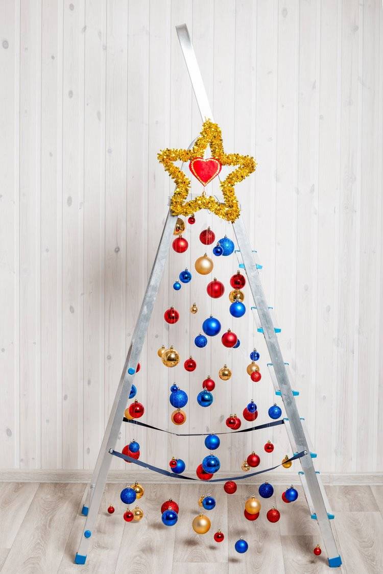 metal ladder decorated as Christmas tree with colorful ornaments