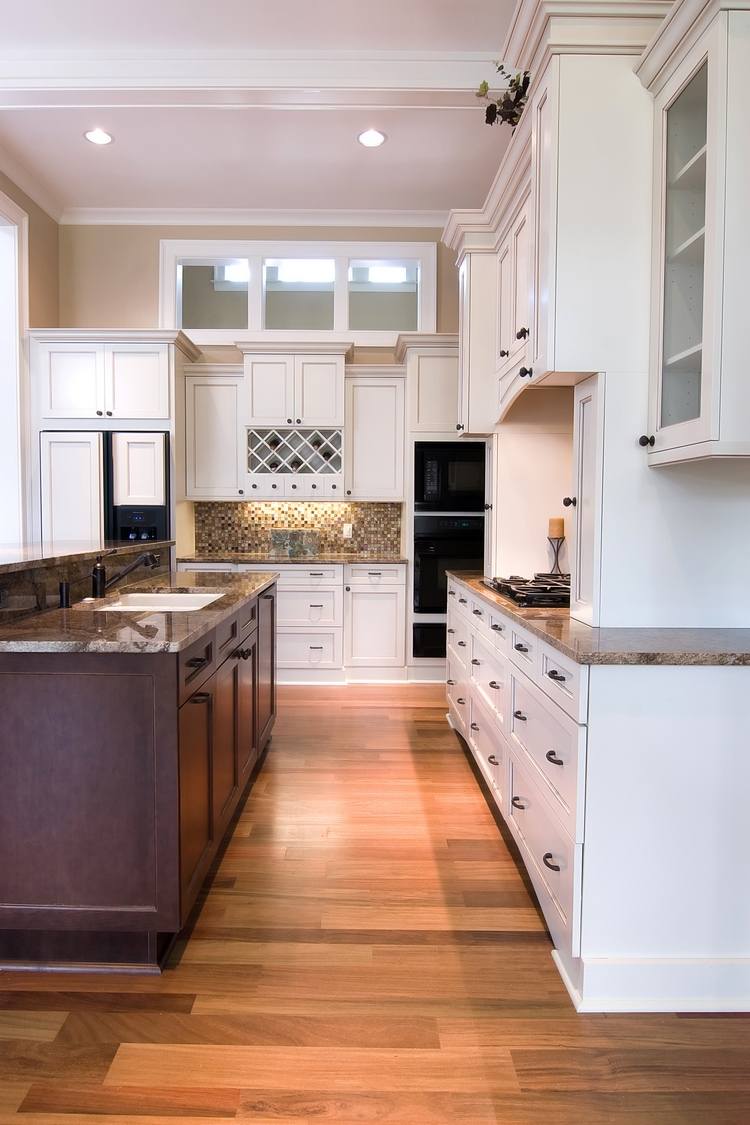 modern white kitchen cabinets wood flooring and granite countertops