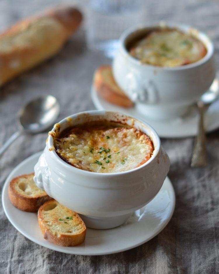 French onion soup in bowls and bread with cheese