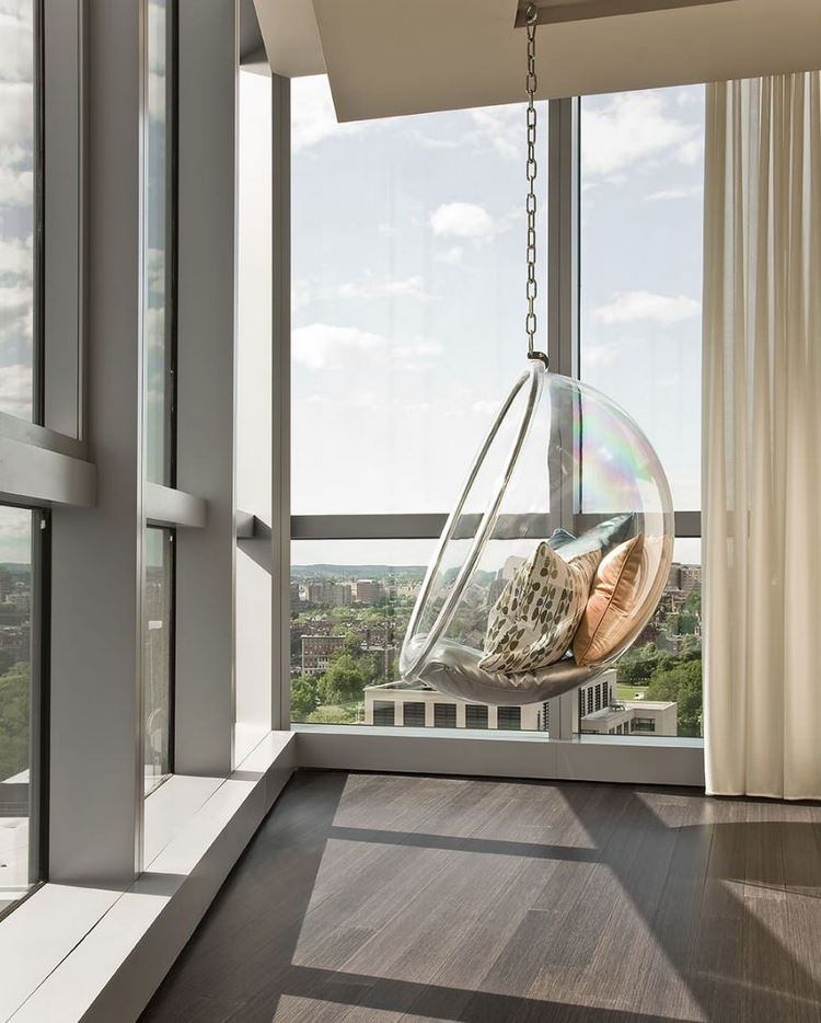 See through hanging bubble chair in contemporary apartment