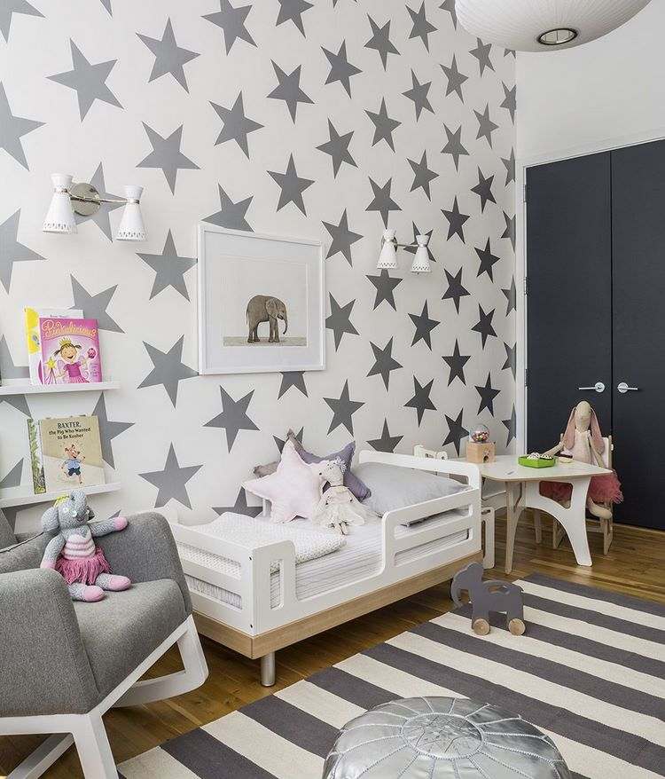 grey and white nursery room design with striped area rug 