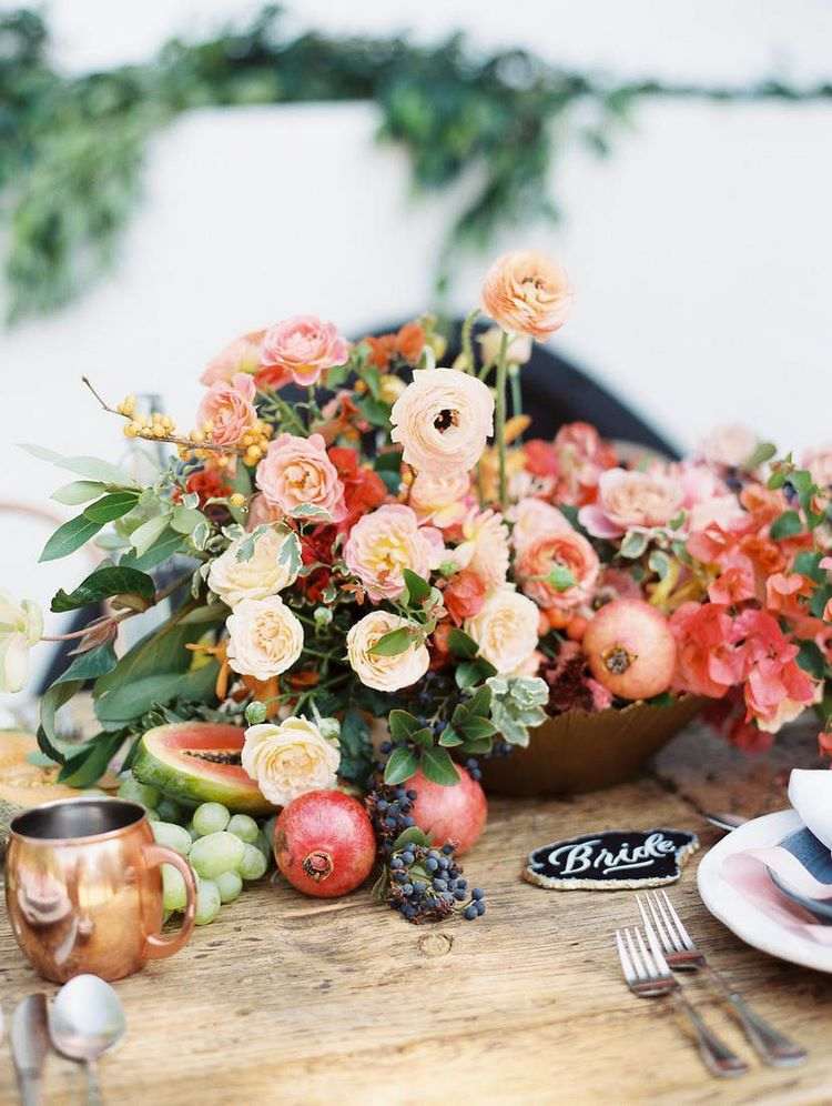beautiful table centerpiece with flowers and fruits