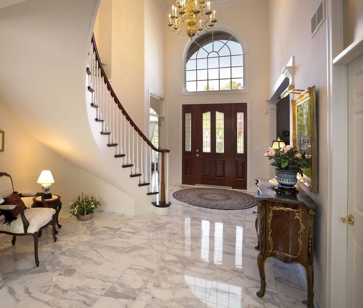 grand foyer with marble floor staircase and chandelier