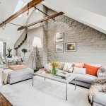 attic-living-room-with-whitewashed-brick-wall-and-exposed-beams