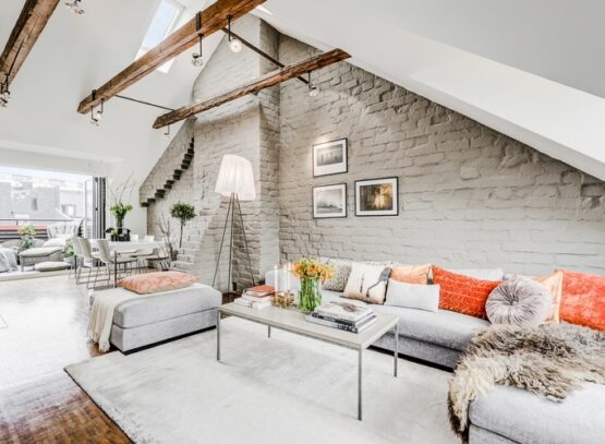 attic-living-room-with-whitewashed-brick-wall-and-exposed-beams