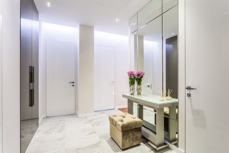 elegant entryway with white marble floor and large mirrors