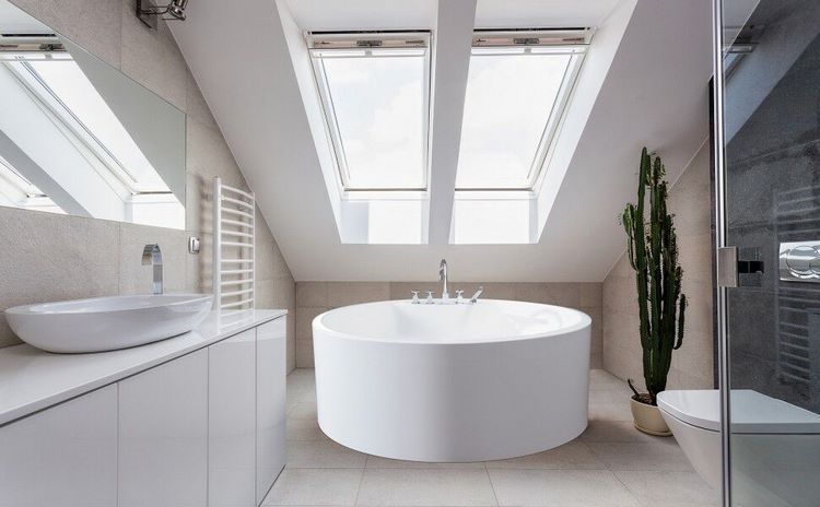 attic bathroom with freestanding tub and walk in shower