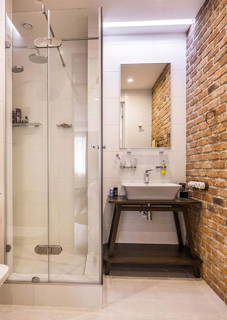 small guest bathroom with brick wall decor and shower