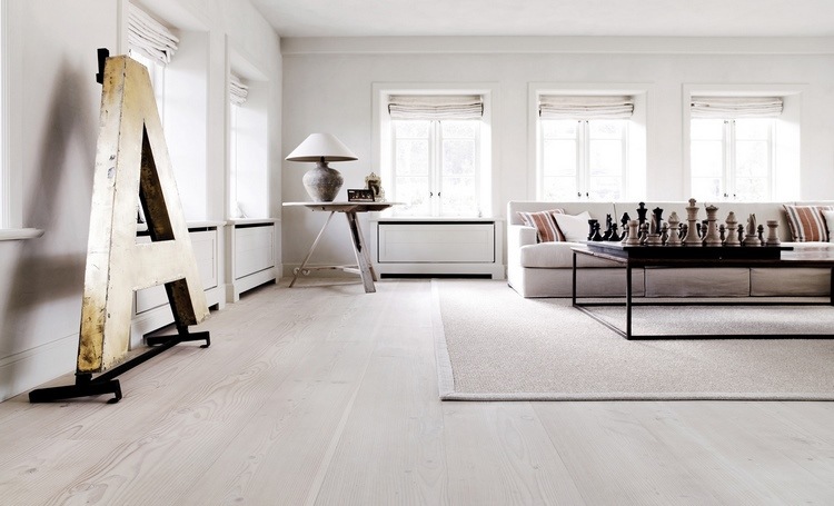 white hardwood floor in living room and white walls