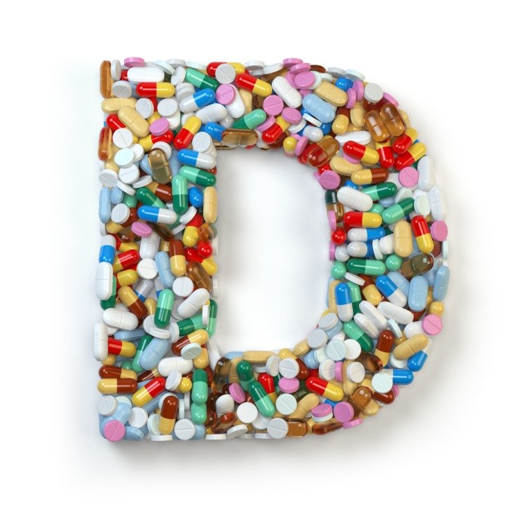capsules and medication forming vitamin d letter
