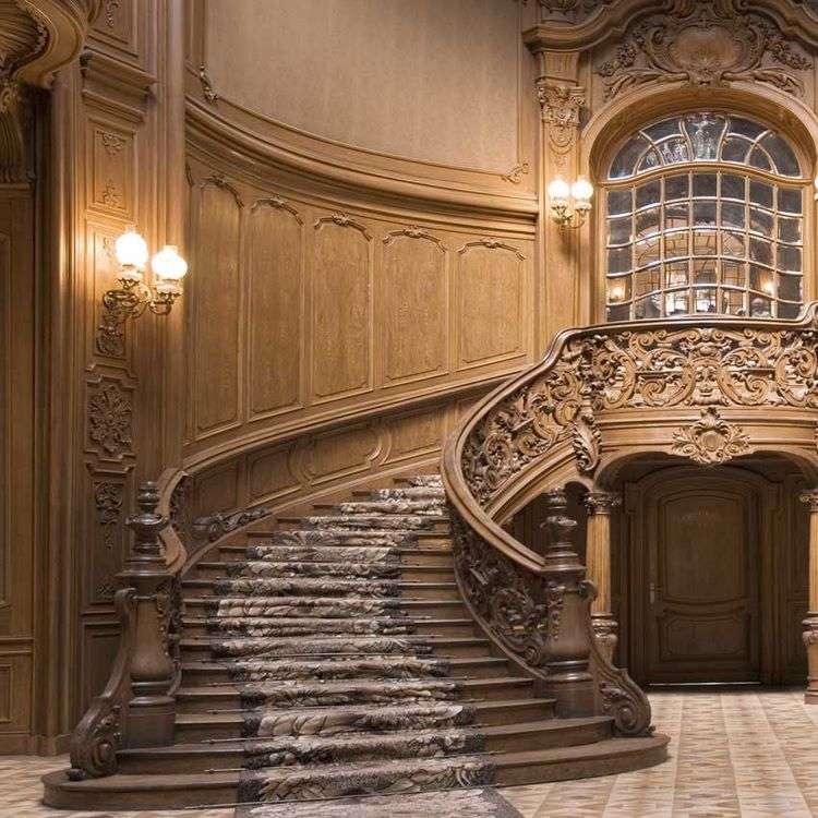 Oak staircase with intricately carved wooden railing