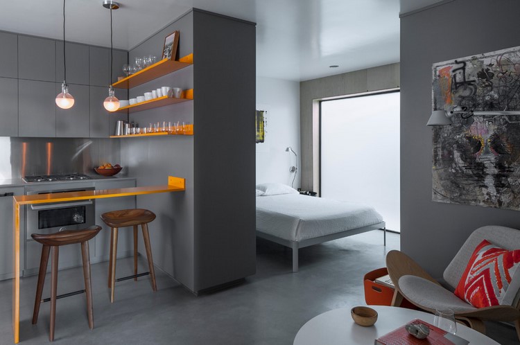 small apartment design in grey with orange accents