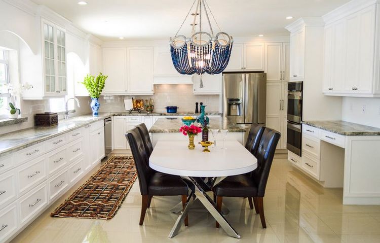 Large kitchen with beautiful blue beaded chandelier over the table