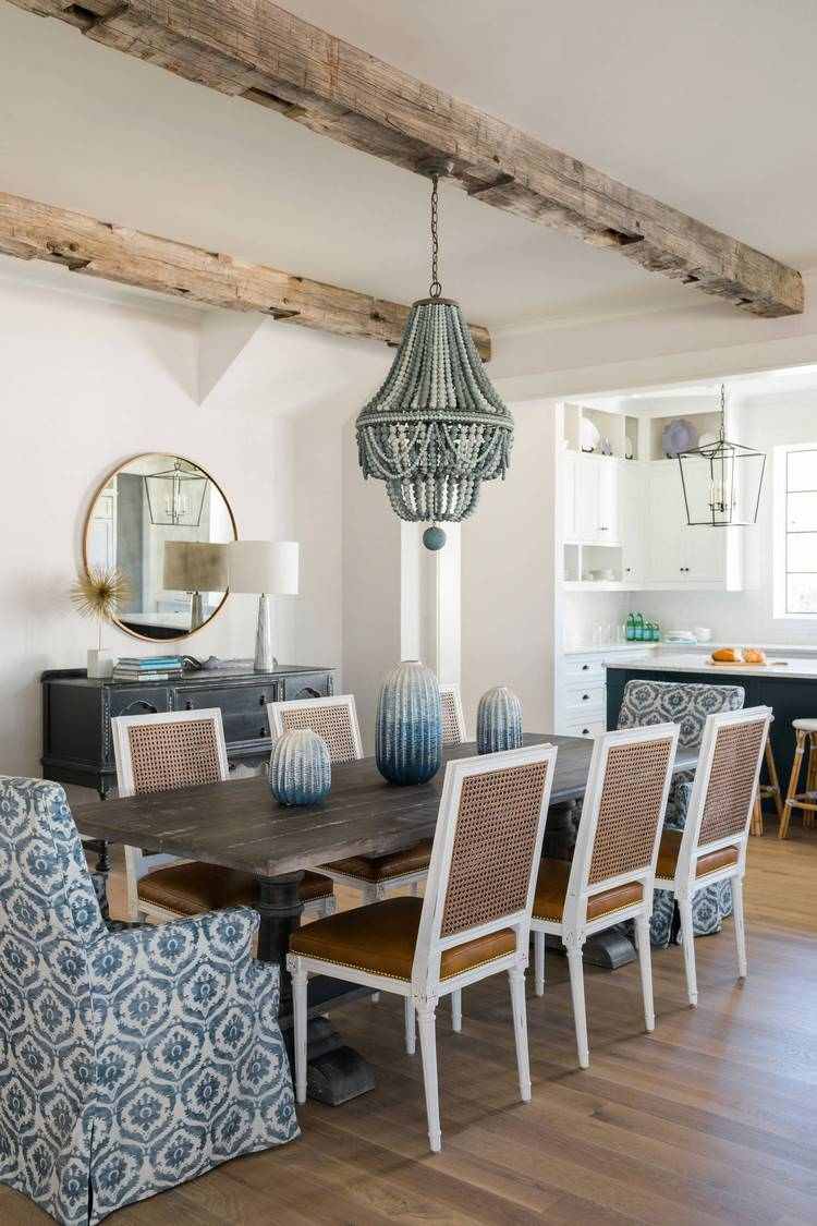 dining room with exposed ceiling beams and beaded chandelier