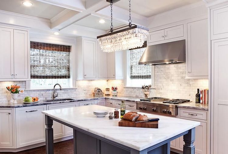 large chandelier above kitchen island coffered ceiling with recessed lights