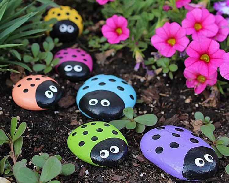 lovely ladybugs from painted rocks as garden decoration