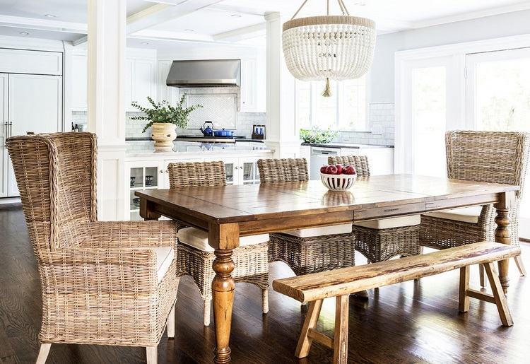 open plan living space dining area with wooden table and beaded chandelier