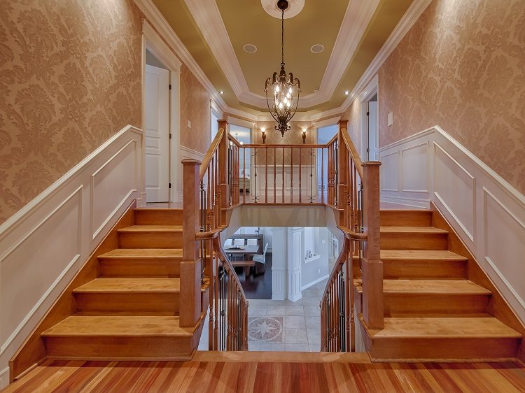 double wooden staircases with pendant chandelier
