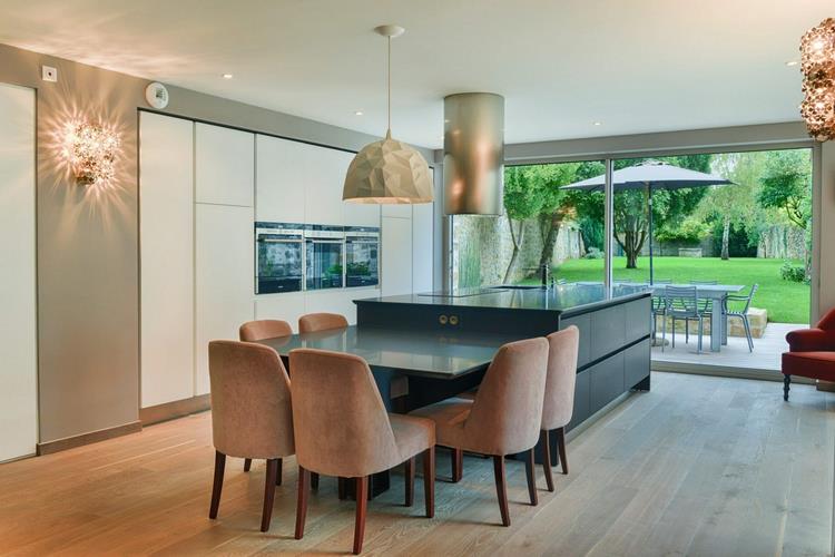 modern kitchen design island with cantilevered table upholstered dining chairs