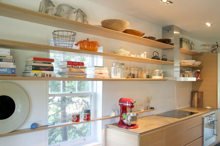 open kitchen shelves across windows as additional storage space