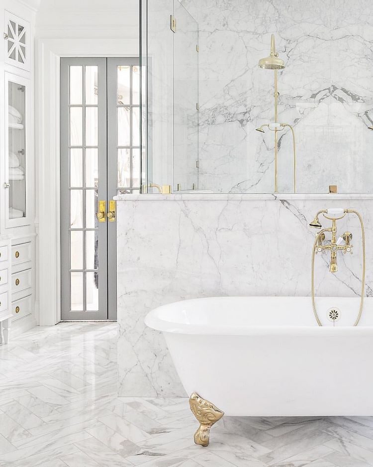 white bathroom with clawfoot tub and walk in shower