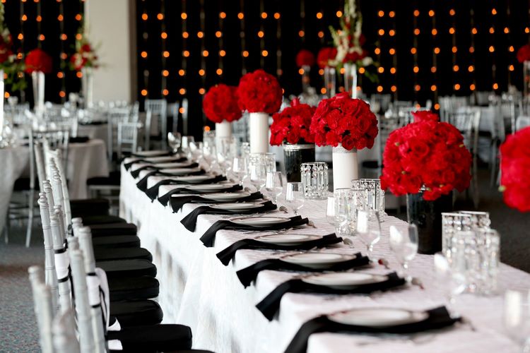 black and white wedding table decoration with red floral centerpieces