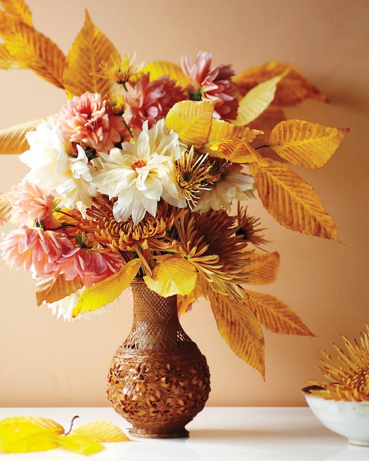 fall bouquet from fresh flowers and colored leaves