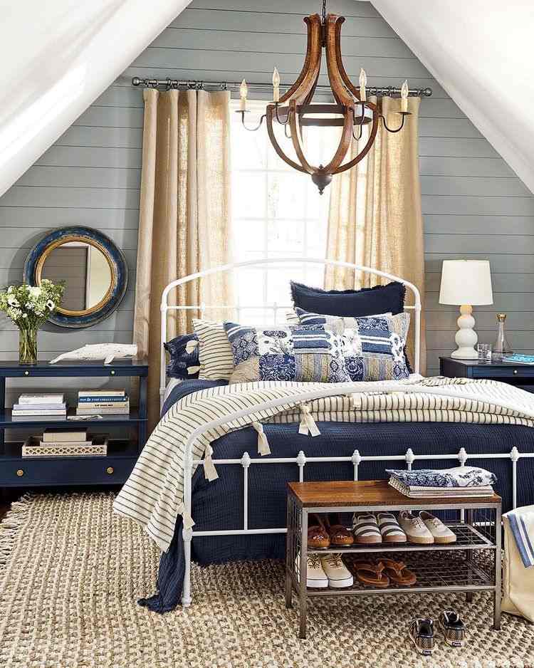 attic bedroom with cathedral ceiling and bed in front of window