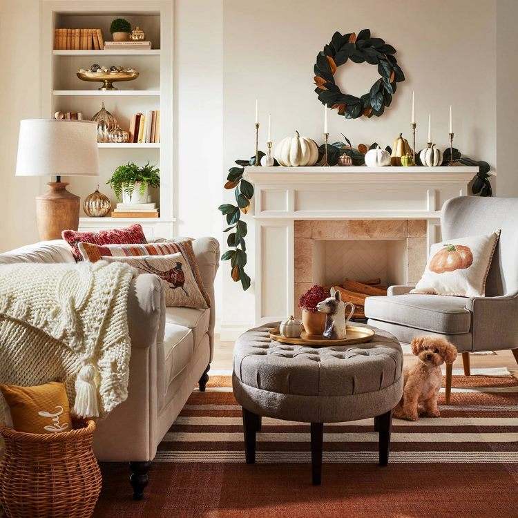 living room fall decor with pillows and pumpkins
