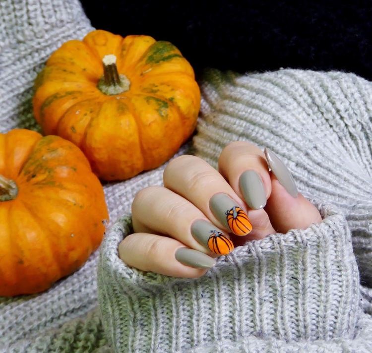 gray manicure with orange pumpkins
