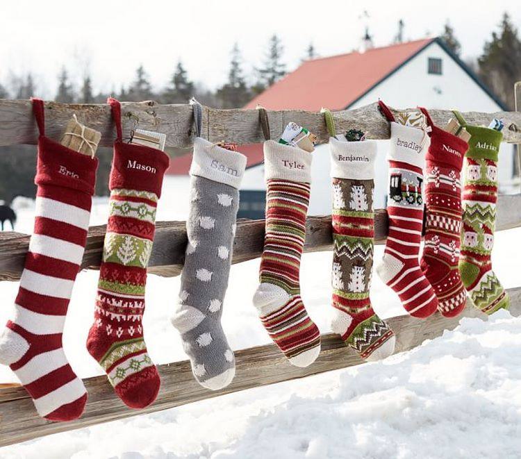 hang Christmas stockings on the fence