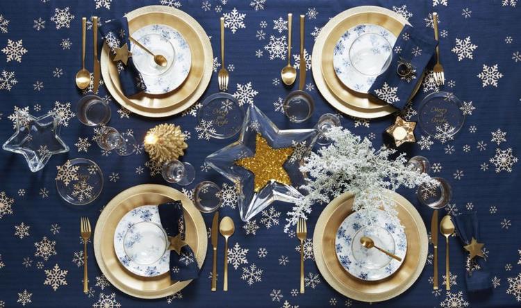 new years table decoration in gold with blue tablecloth
