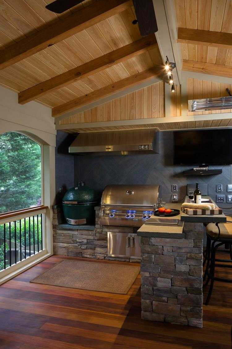 Cooking and grilling outdoors backyard kitchen design wood natural stone