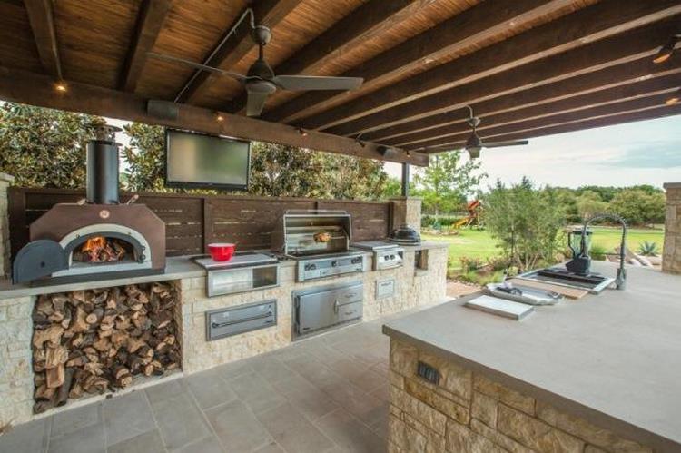 outdoor kitchen with pizza oven and gas grill