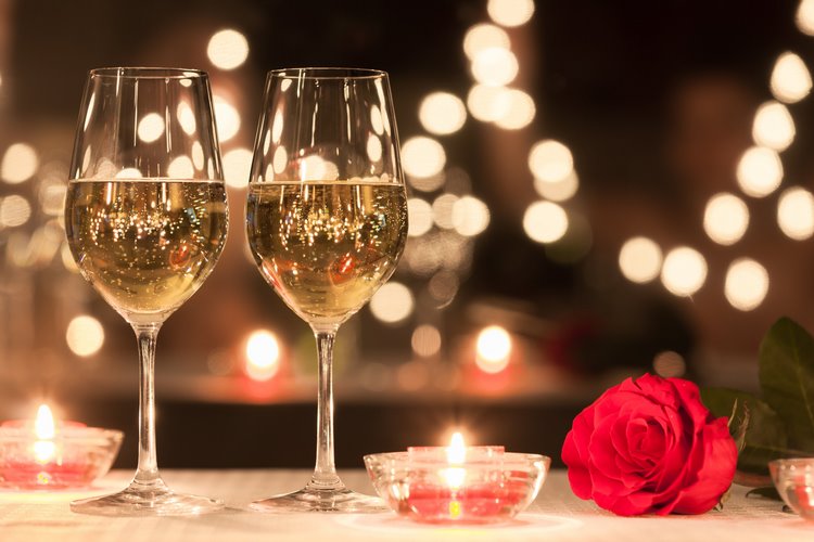 romantic table setting for Valentines day glasses of wine and candles