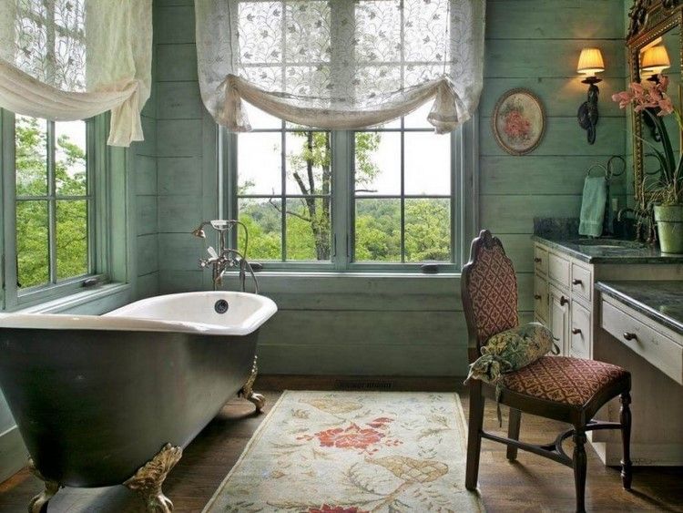 master bathroom with clawfoot tub and vanity table