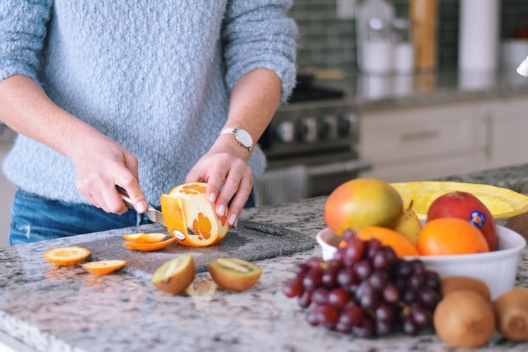 woman is peeling an orange delicious jam recipe