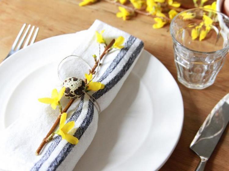 Easter napkin decorated with yellow forsythia and quail egg