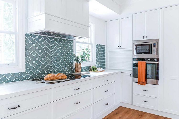 white kitchen cabinets fish scale tile backsplash
