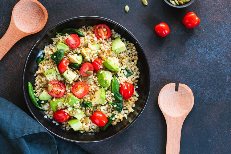 Healthy salad with bulgur avocado and spinach