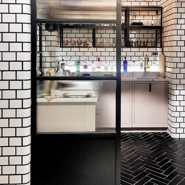 glass kitchen partition black herringbone floor white wall tile