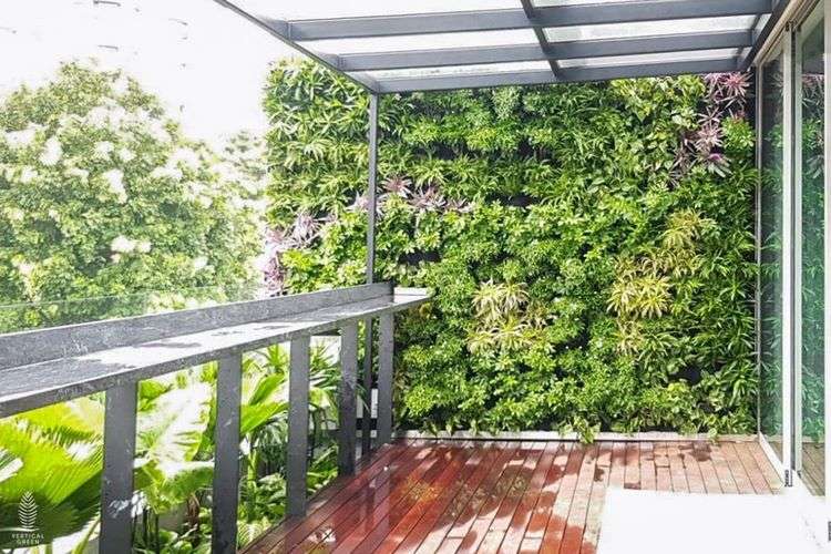 A living vertical garden wall provides privacy on the balcony