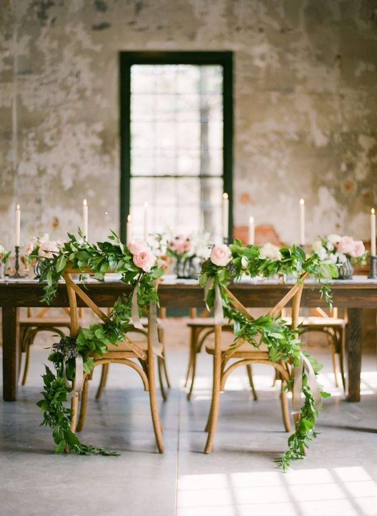 greenery garlands as wedding chair decoration