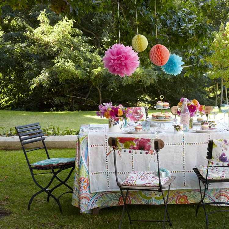 pompoms above table outdoor party decor ideas
