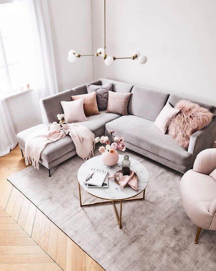living room with gray sofa and blush pink accessories